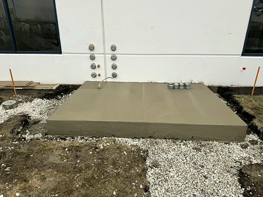 Concrete generator pad poured at the base of a steel column